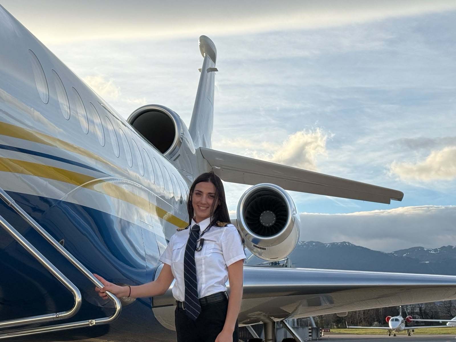 Ilhame Guechati beside a private jet